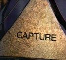 [Adam runs the abacus, and the triangle that said 'junkyard' now says 'capture'.]