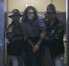 [Shackled and gagged, Adam is taken to Ricanto Federal Prison.]